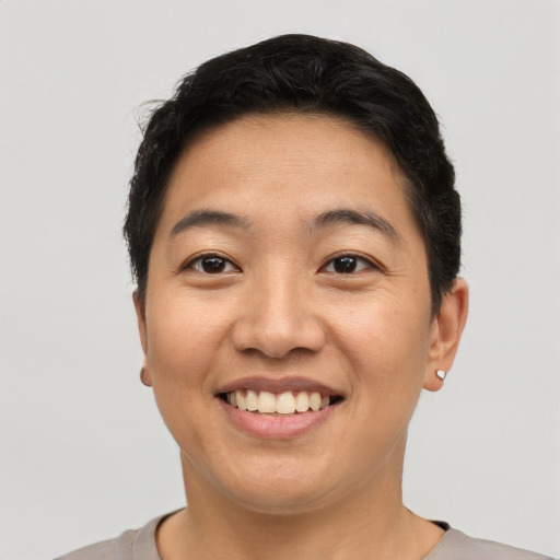 Joyful asian young-adult female with short  black hair and brown eyes