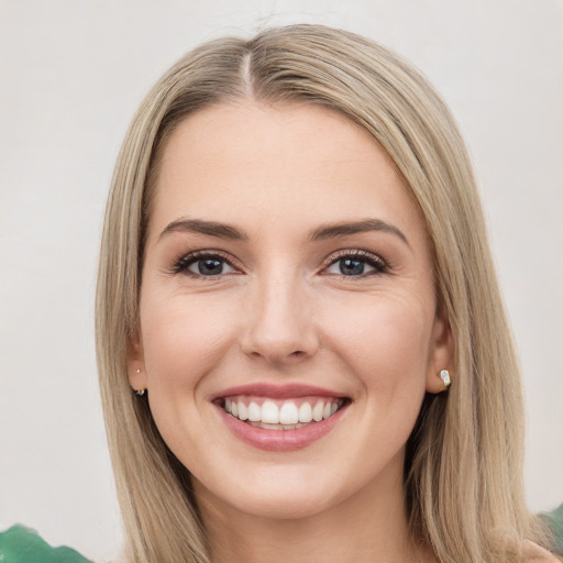 Joyful white young-adult female with long  brown hair and green eyes