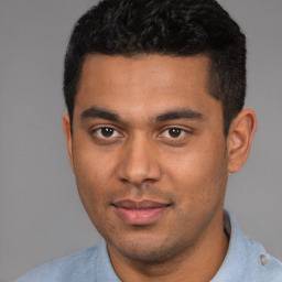 Joyful latino young-adult male with short  black hair and brown eyes