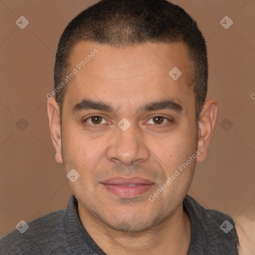 Joyful latino adult male with short  brown hair and brown eyes