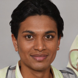 Joyful latino young-adult male with short  brown hair and brown eyes