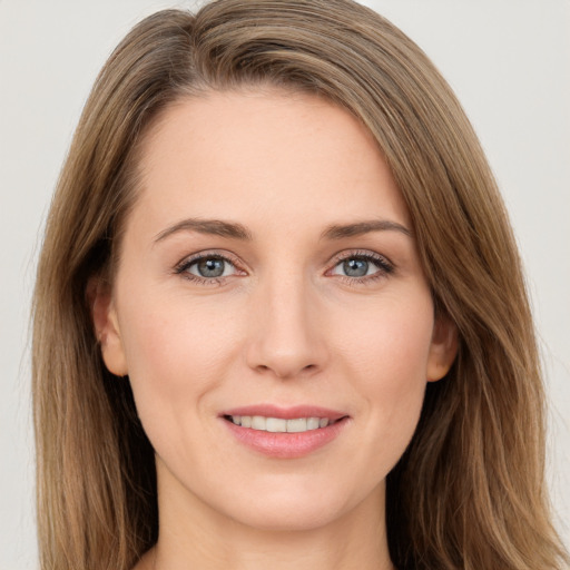 Joyful white young-adult female with long  brown hair and grey eyes