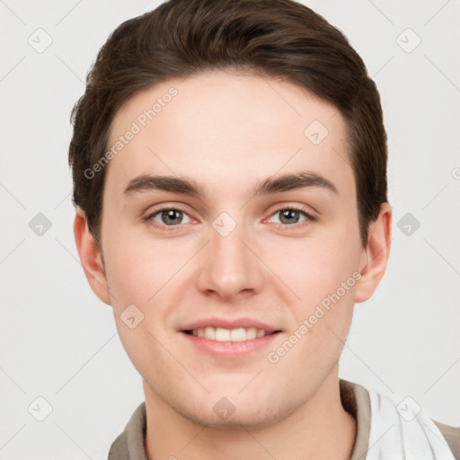 Joyful white young-adult male with short  brown hair and grey eyes