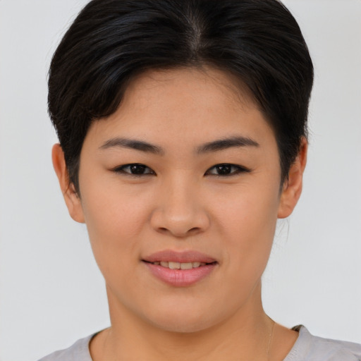 Joyful asian young-adult female with short  brown hair and brown eyes