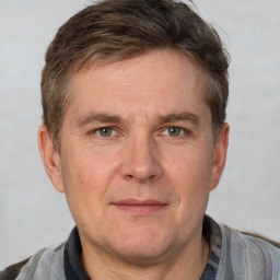 Joyful white adult male with short  brown hair and grey eyes