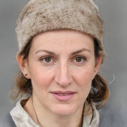 Joyful white adult female with medium  brown hair and grey eyes