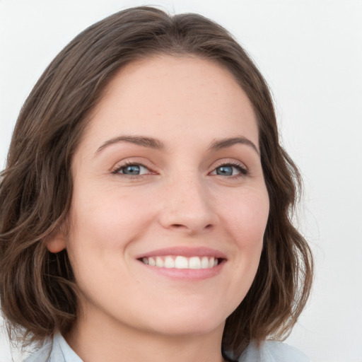 Joyful white young-adult female with medium  brown hair and green eyes