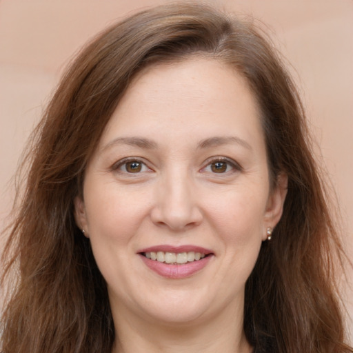 Joyful white adult female with long  brown hair and brown eyes