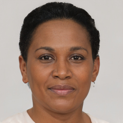 Joyful black adult female with short  brown hair and brown eyes