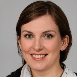 Joyful white young-adult female with medium  brown hair and blue eyes