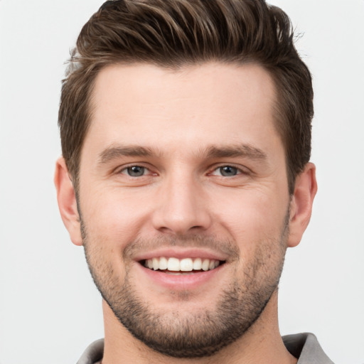 Joyful white young-adult male with short  brown hair and brown eyes