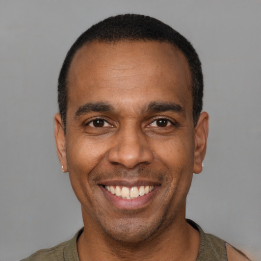 Joyful latino adult male with short  black hair and brown eyes