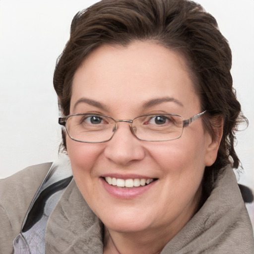 Joyful white adult female with medium  brown hair and grey eyes