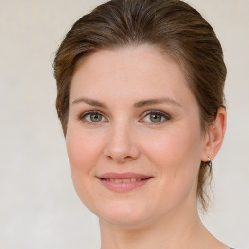 Joyful white young-adult female with medium  brown hair and green eyes