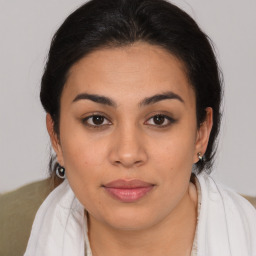 Joyful latino young-adult female with medium  brown hair and brown eyes