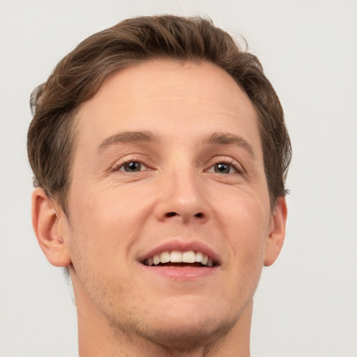 Joyful white adult male with short  brown hair and grey eyes