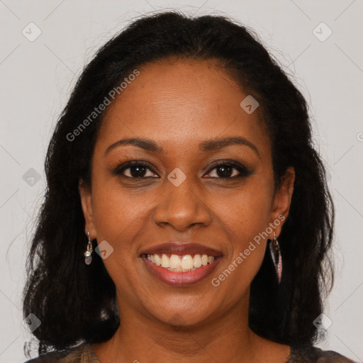 Joyful black young-adult female with long  brown hair and brown eyes