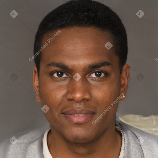 Joyful black young-adult male with short  brown hair and brown eyes