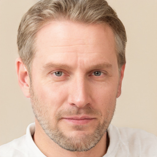 Joyful white adult male with short  brown hair and grey eyes