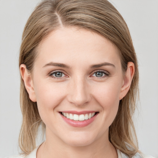 Joyful white young-adult female with medium  brown hair and blue eyes