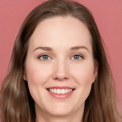 Joyful white young-adult female with long  brown hair and blue eyes