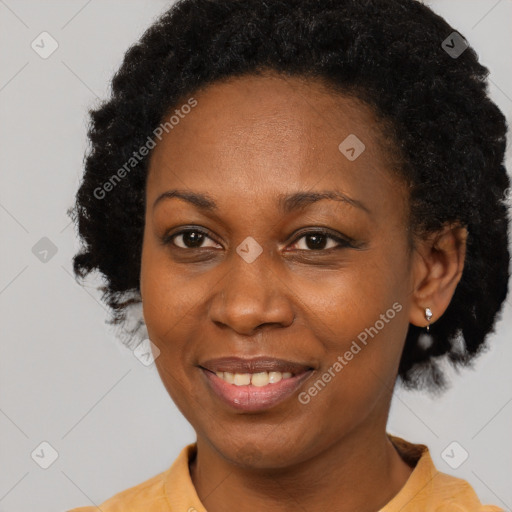 Joyful black adult female with short  black hair and brown eyes