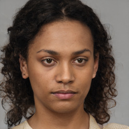 Neutral black young-adult female with medium  brown hair and brown eyes