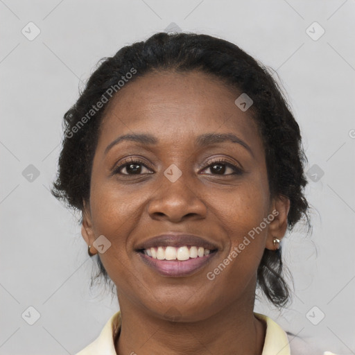 Joyful black adult female with long  brown hair and brown eyes