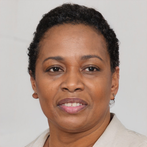 Joyful black adult female with short  black hair and brown eyes
