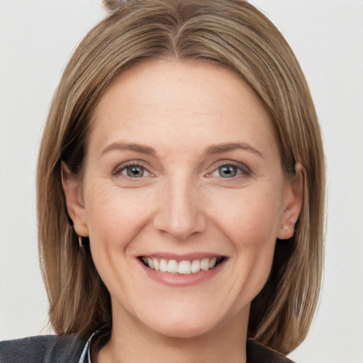 Joyful white adult female with medium  brown hair and grey eyes