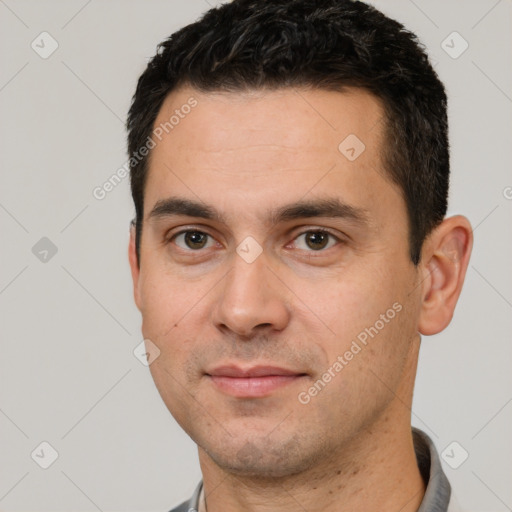 Joyful white young-adult male with short  black hair and brown eyes