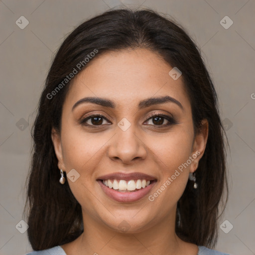 Joyful latino young-adult female with medium  brown hair and brown eyes