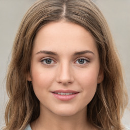 Joyful white young-adult female with long  brown hair and green eyes