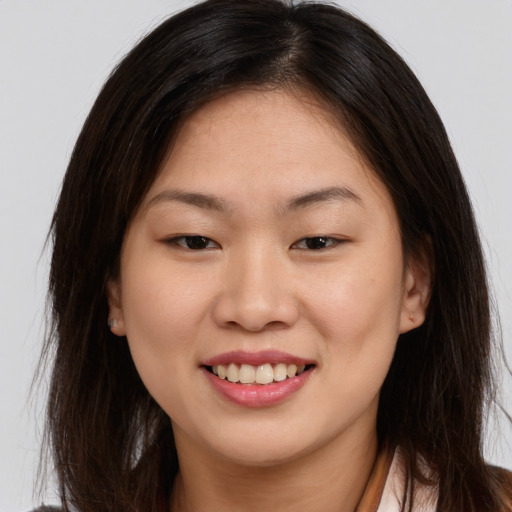 Joyful white young-adult female with long  brown hair and brown eyes