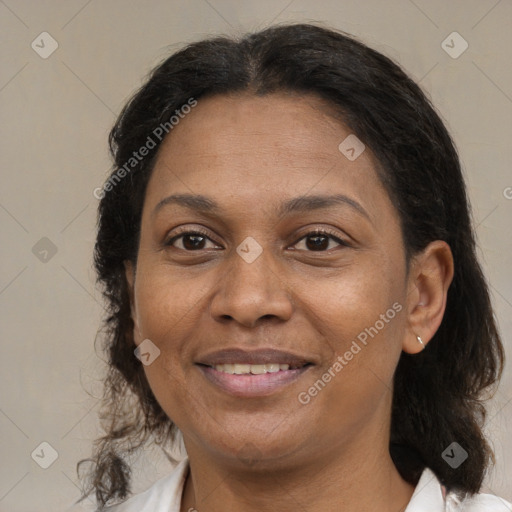 Joyful latino adult female with medium  brown hair and brown eyes