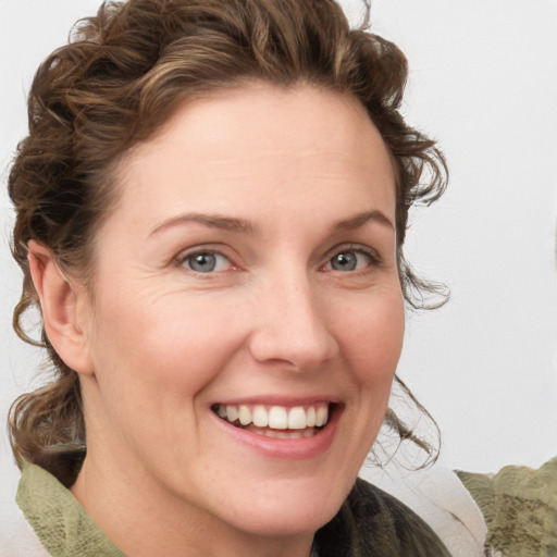 Joyful white young-adult female with medium  brown hair and green eyes