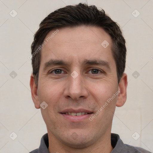 Joyful white adult male with short  brown hair and brown eyes