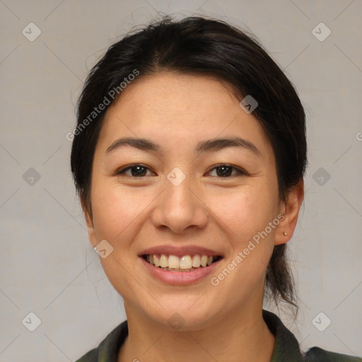 Joyful asian young-adult female with medium  brown hair and brown eyes