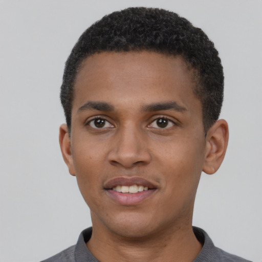 Joyful black young-adult male with short  brown hair and brown eyes