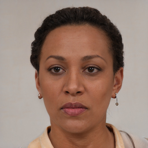 Neutral latino adult female with short  brown hair and brown eyes