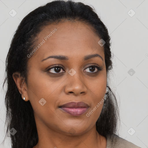 Joyful black young-adult female with long  brown hair and brown eyes