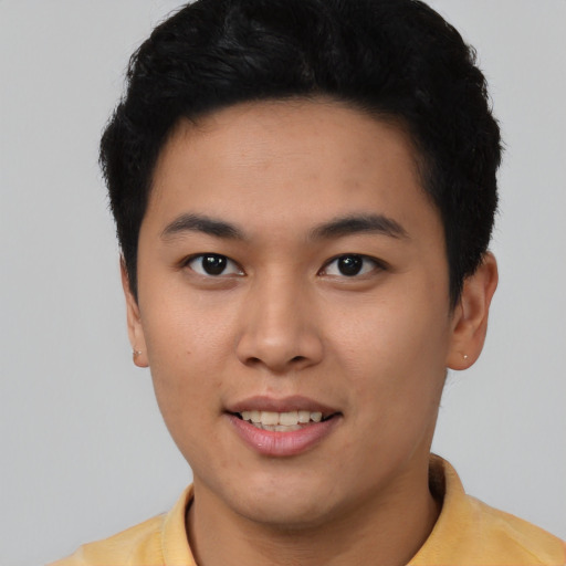 Joyful latino young-adult male with short  brown hair and brown eyes