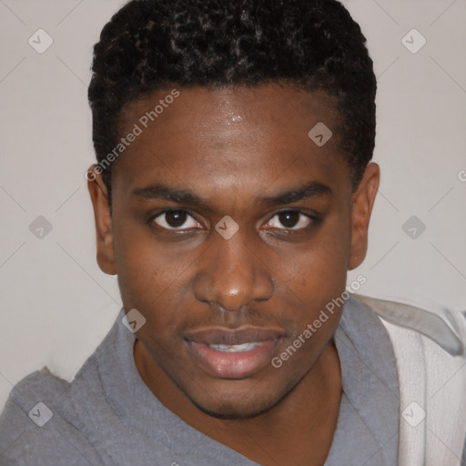 Joyful black young-adult male with short  brown hair and brown eyes