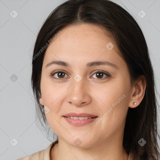 Joyful white young-adult female with long  brown hair and brown eyes