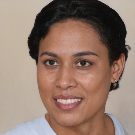 Joyful black young-adult female with short  brown hair and brown eyes