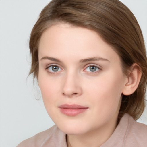 Joyful white young-adult female with medium  brown hair and blue eyes