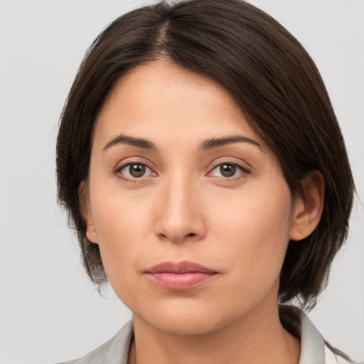 Neutral white young-adult female with medium  brown hair and brown eyes