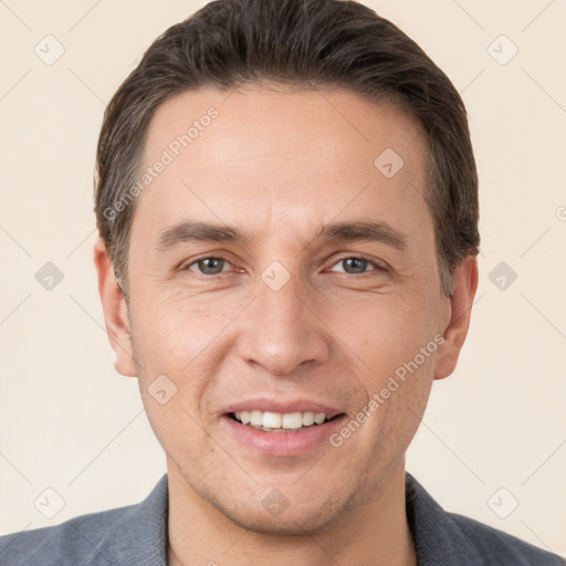 Joyful white adult male with short  brown hair and brown eyes