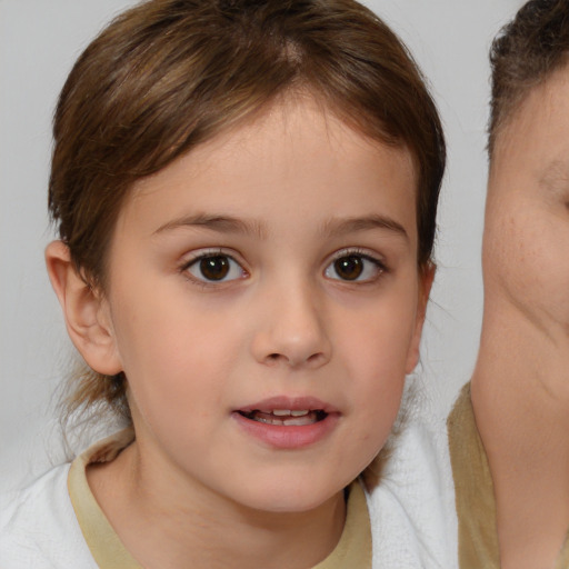 Joyful white child female with medium  brown hair and brown eyes