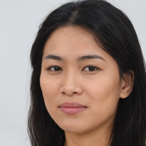 Joyful asian young-adult female with long  brown hair and brown eyes